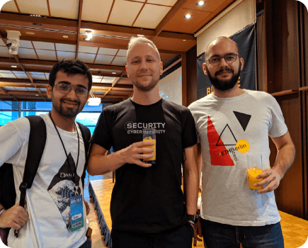 Rasikh Morani with two others at a blockchain conference